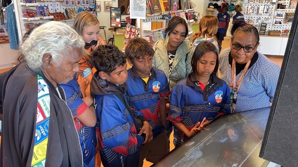 Sophia Mung & Shirley Drill & Purnululu School students with the Jirraginy joo Goorrarndal - Frog and Brolga Interactive Display Panel at Purnululu 